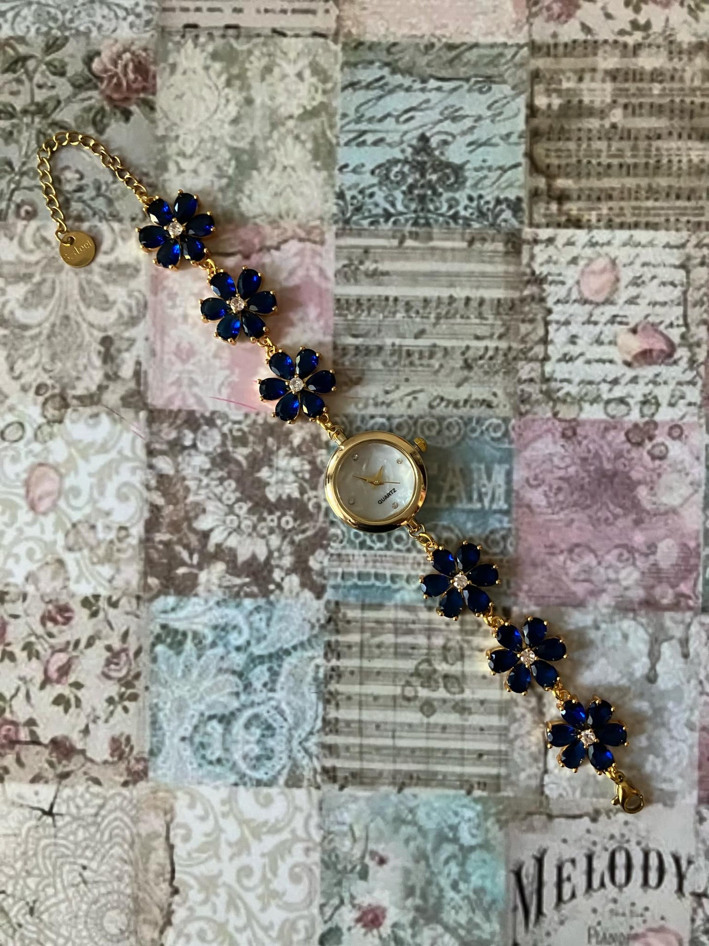 Gold Flower Watch with Dark Blue Stones